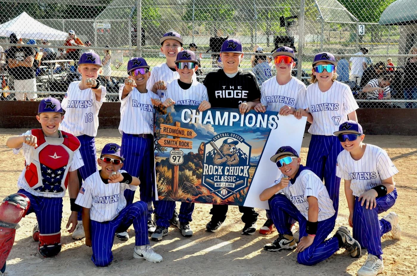 A Ravens team celebrating with their Rock Chuck Classic champions banner